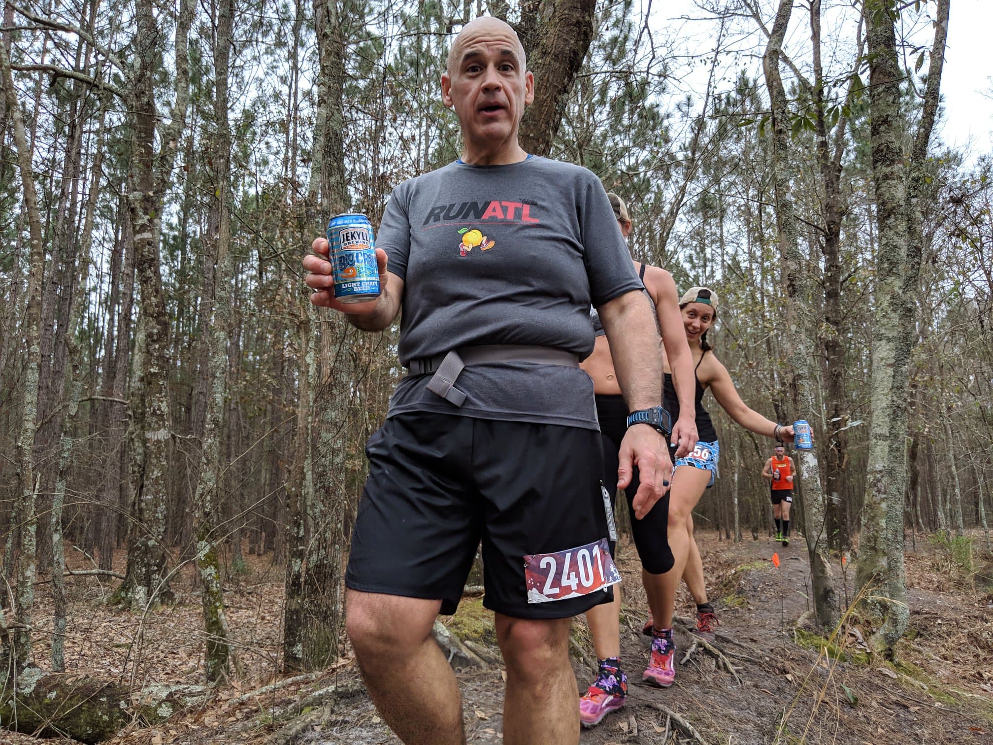 Runner holding a beer mid-race